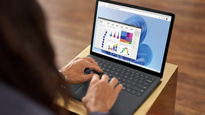 A person working on a budget breakdown on a laptop