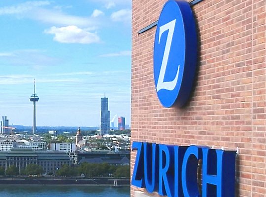 A city skyline behind the Zurich Insurance building.