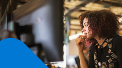A top-down view of a person working at their desk in a dark room.