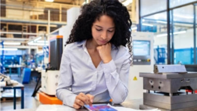 A person working on a tablet in an office.