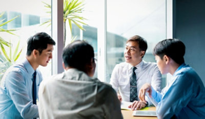 Group of professionals discussing strategic plans in a meeting room.