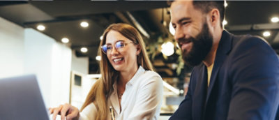 A man and woman smiling.