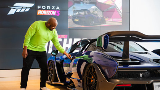 Associate with a customer by the McLaren Senna simulator.