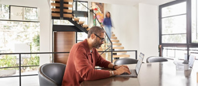 A person sitting at a desk using a computer