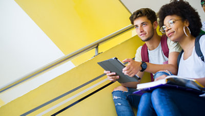 Teen students sit together on a stairwell