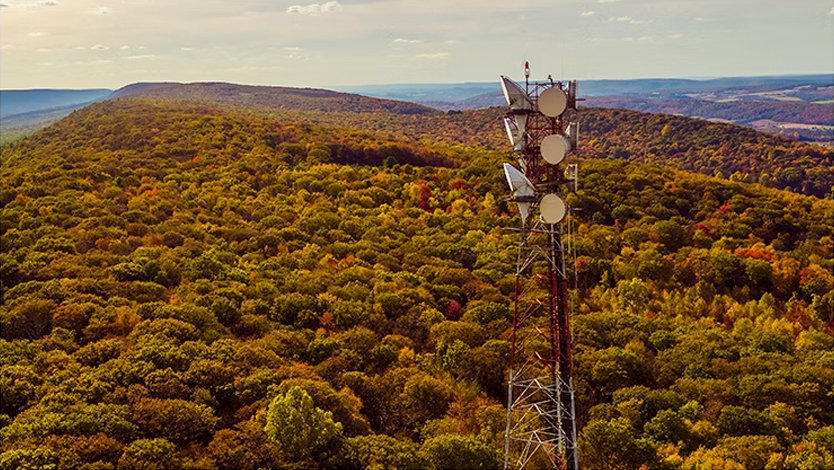 A telecommunication tower on a mountain ridge in the Appalachian Mountains in the fall.