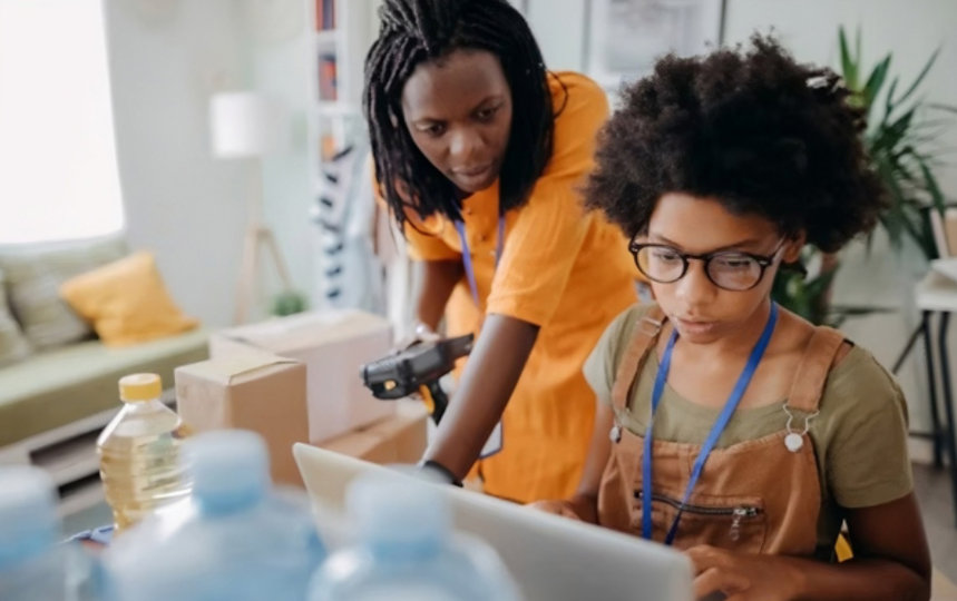 Two people looking at a laptop.
