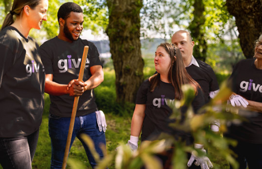 Volunteers work together outdoors.