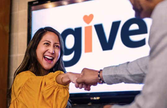 Two people share a joyful fist bump.