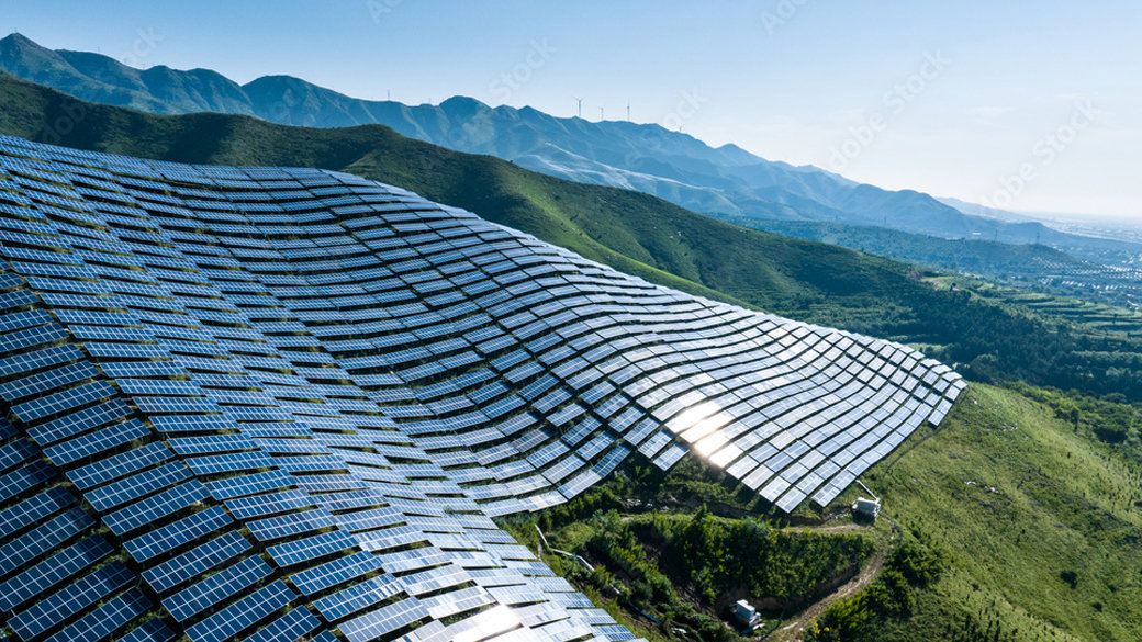 Solar panels cover a hillside to collect solar energy.
