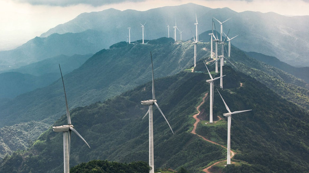 Wind turbines are generating energy on a mountain ridge.