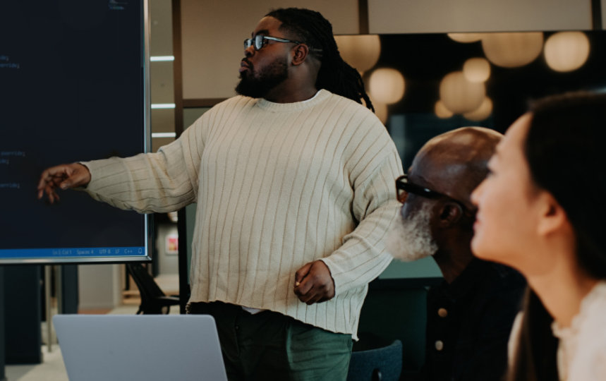 Man giving a presentation to co-workers in a business meeting. 