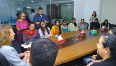 A group of mostly women in a business meeting.