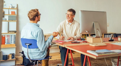 Two people talking in an office.