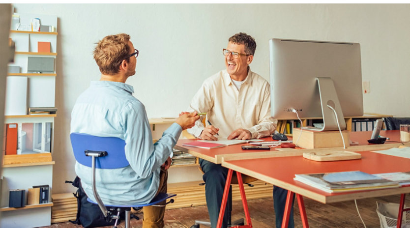 Two people talking in an office.