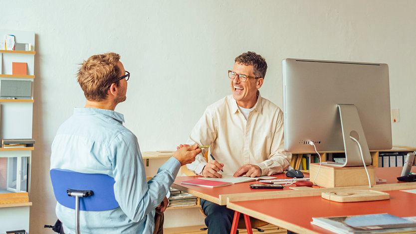 Two people talking in an office.