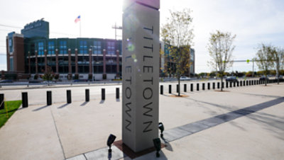 A shot of the Titletown pillar standing in front of the Green Bay Packers' own Lambeau Field.