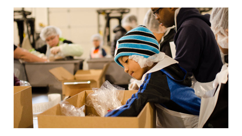 Volunteers packing boxes together