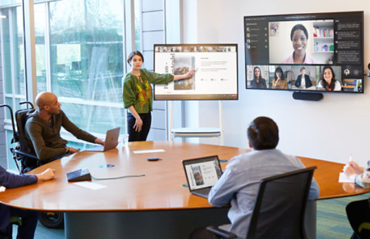 Colleague delivering presentation while colleagues listen attentively.