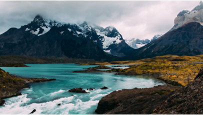 Proglacial river running through snowy mountains.