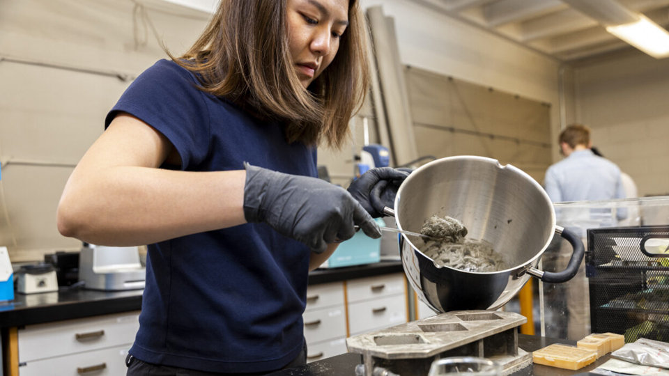 A member of Eleftheria Roumeli’s lab at the University of Washington, mixes up seaweed-containing batter for making cement.