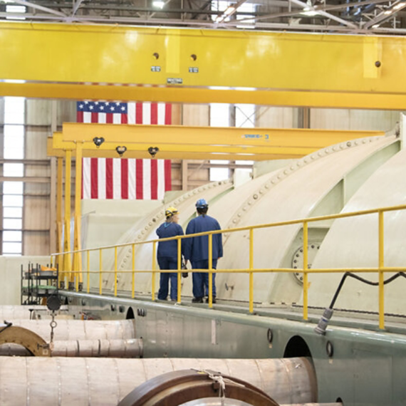 Technicians walk inside the Crane Clean Energy Center.