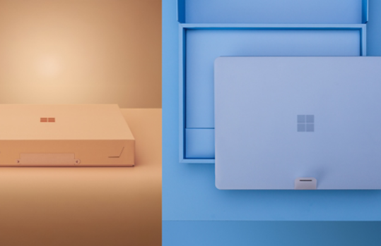 Surface packaging with a closed box on the left and an open box showing a Surface device on the right.