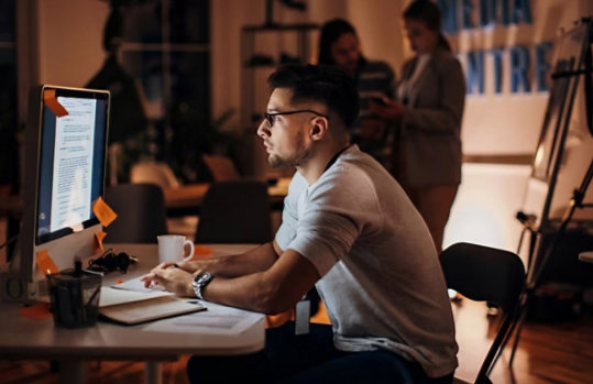 A man working at a computer in an office.