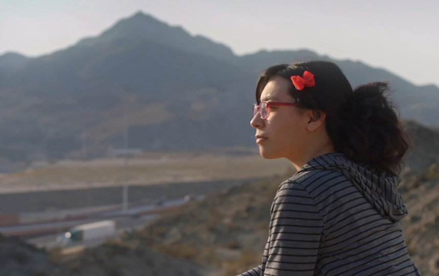 Wendy Sandoval looking out over a mountainous landscape.