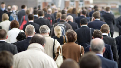 Crowd of commuters walking in the street.