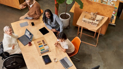 Aerial view of a group of co-workers on a conference call.