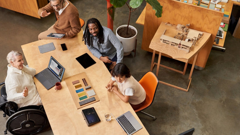 Aerial view of a group of co-workers on a conference call.