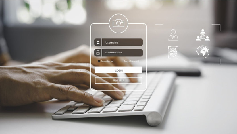 Login interface overlay on a person typing at a white keyboard, with icons for user, fingerprint, camera, and globe.