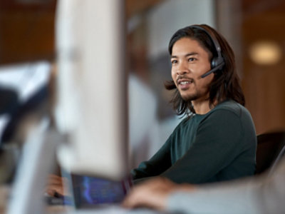 A person is smiling using headphones