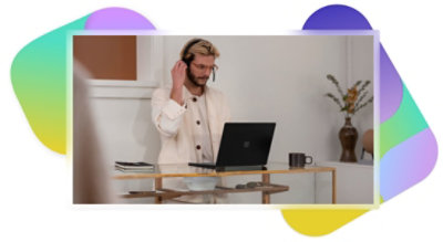 A person wearing a headset and using laptop.