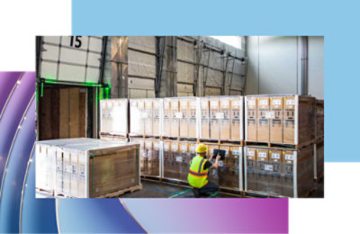 A person in a yellow safety vest working in a warehouse