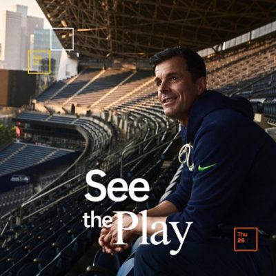 Person seated in a stadium using data insights to prepare for future game decisions.