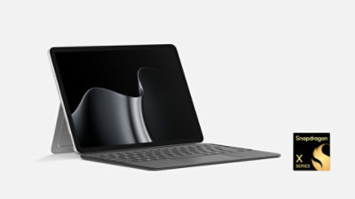 Platinum Surface Pro 12-inch with kickstand and Keyboard, front-left view, Snapdragon X Series. 