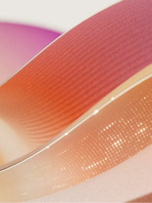 Abstract illustration of flowing ribbons in pinks and oranges.