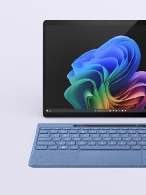 A Sapphire Blue 13-inch Surface Pro with a matching Flex keyboard and black Slim Pen.