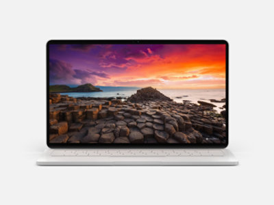 A laptop displaying a colourful seascape from Bing Wallpaper.