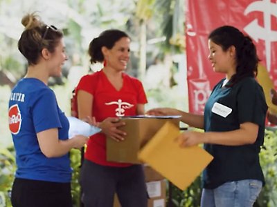 A group of Project CURE team members distributing medical supplies. 