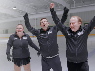 Elizabeth, Deeb, and Cody, Special Olympics figure skaters, celebrating at the rink.