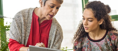 Two women looking at a tablet.