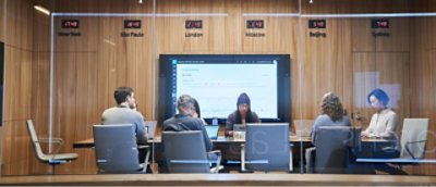 A group of people sitting at a table with the number 2114 visible.