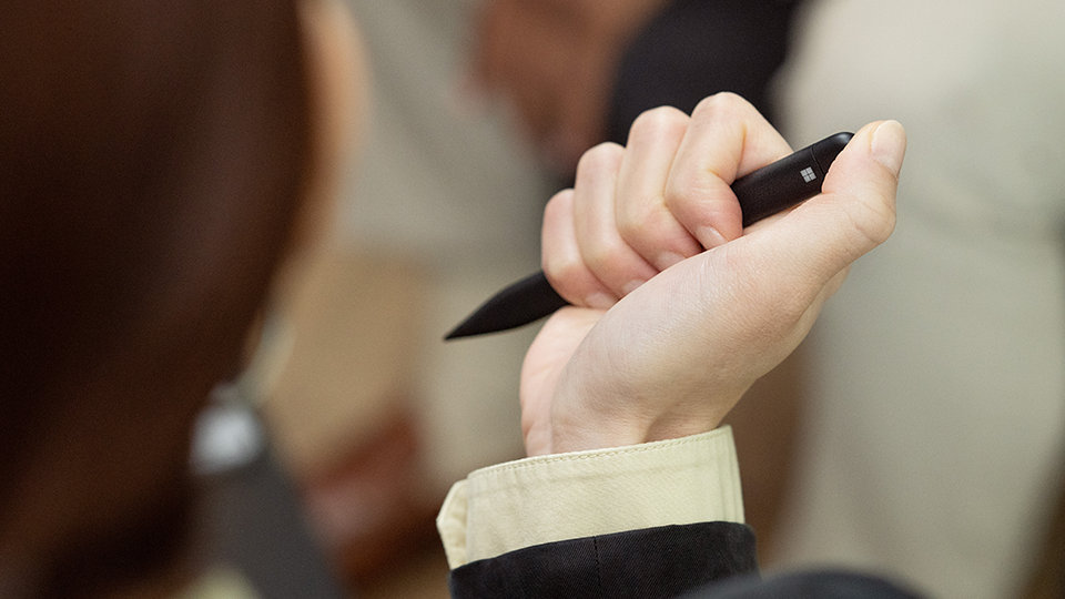 A person holds a Slim Pen 2 for Business.