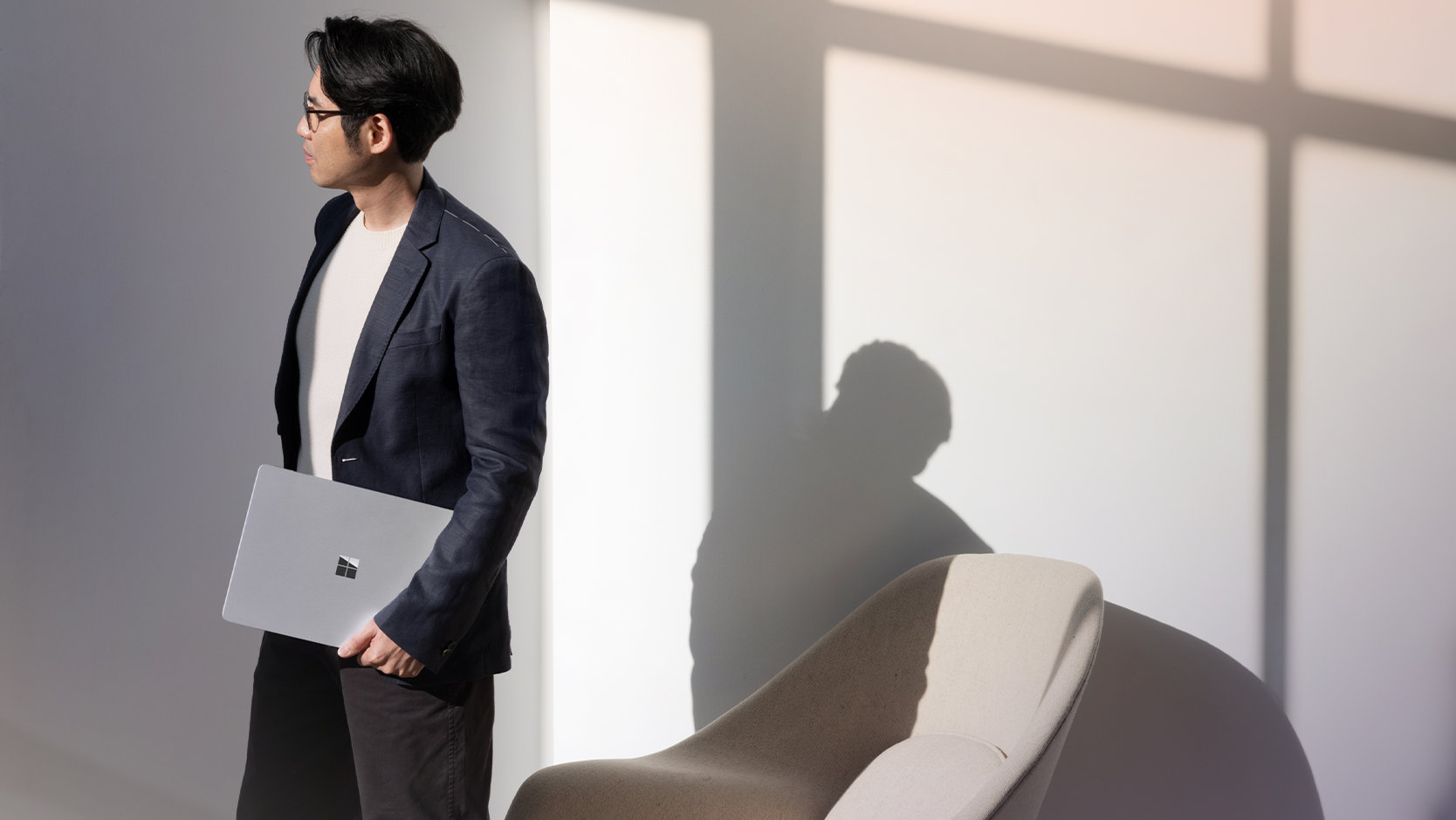 A person holds a Surface Laptop for Business.