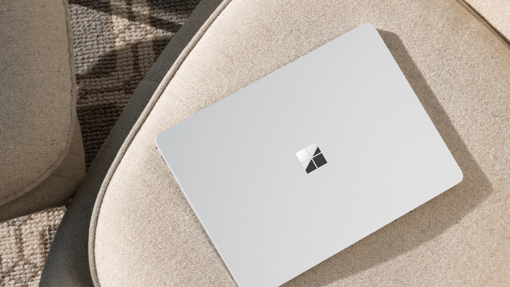 A top-down view of a Surface Laptop for Business device left unattended in a public place, suggesting the security of the device. 