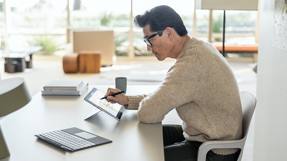 Een persoon bekijkt het werk veilig op Surface Pro 9 voor zakelijk gebruik.