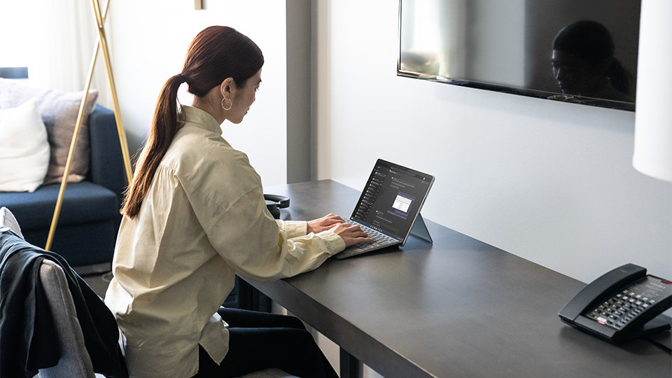 A person uses Surface for Business features on Surface Pro 9 for Business.